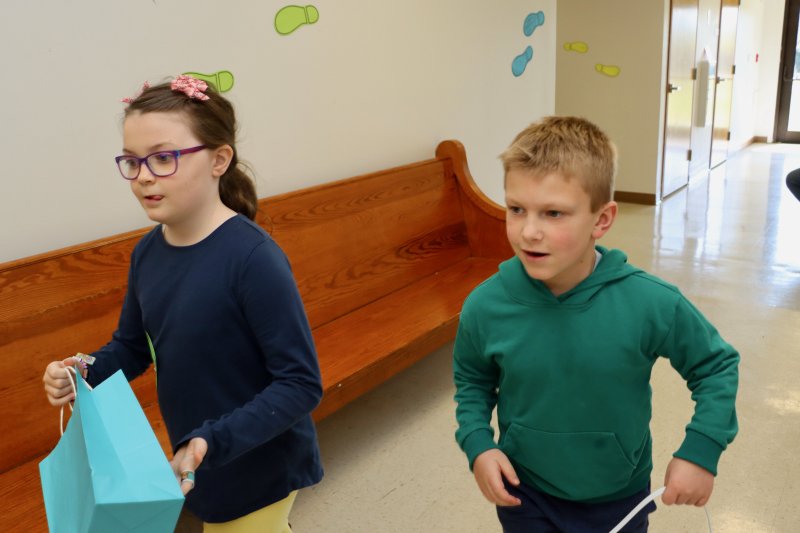 Sara Rae Buckley, left, and Harrison Mrozinski race to find eggs at the Lutheran church.